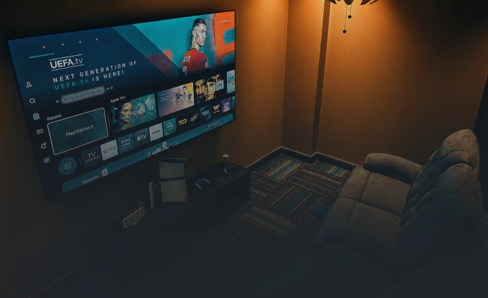 Private PlayStation gaming room with large screen and lounge seating at Playcation.