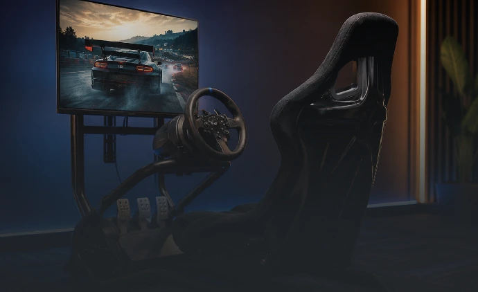 Realistic driving simulator with racing seat, steering wheel, and large screen at Playcation.