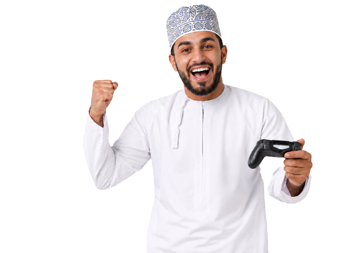 Omani man holding a game controller and enjoying a gaming session at Playcation.