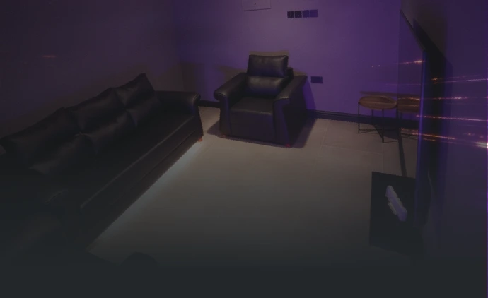 VIP PlayStation room with recliner seating and purple ambient lighting at Playcation.